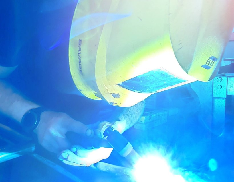Welding in progress — clean, fully-fused joints